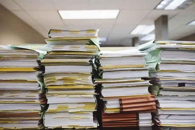 A pile of paper notes representing manual coding.
