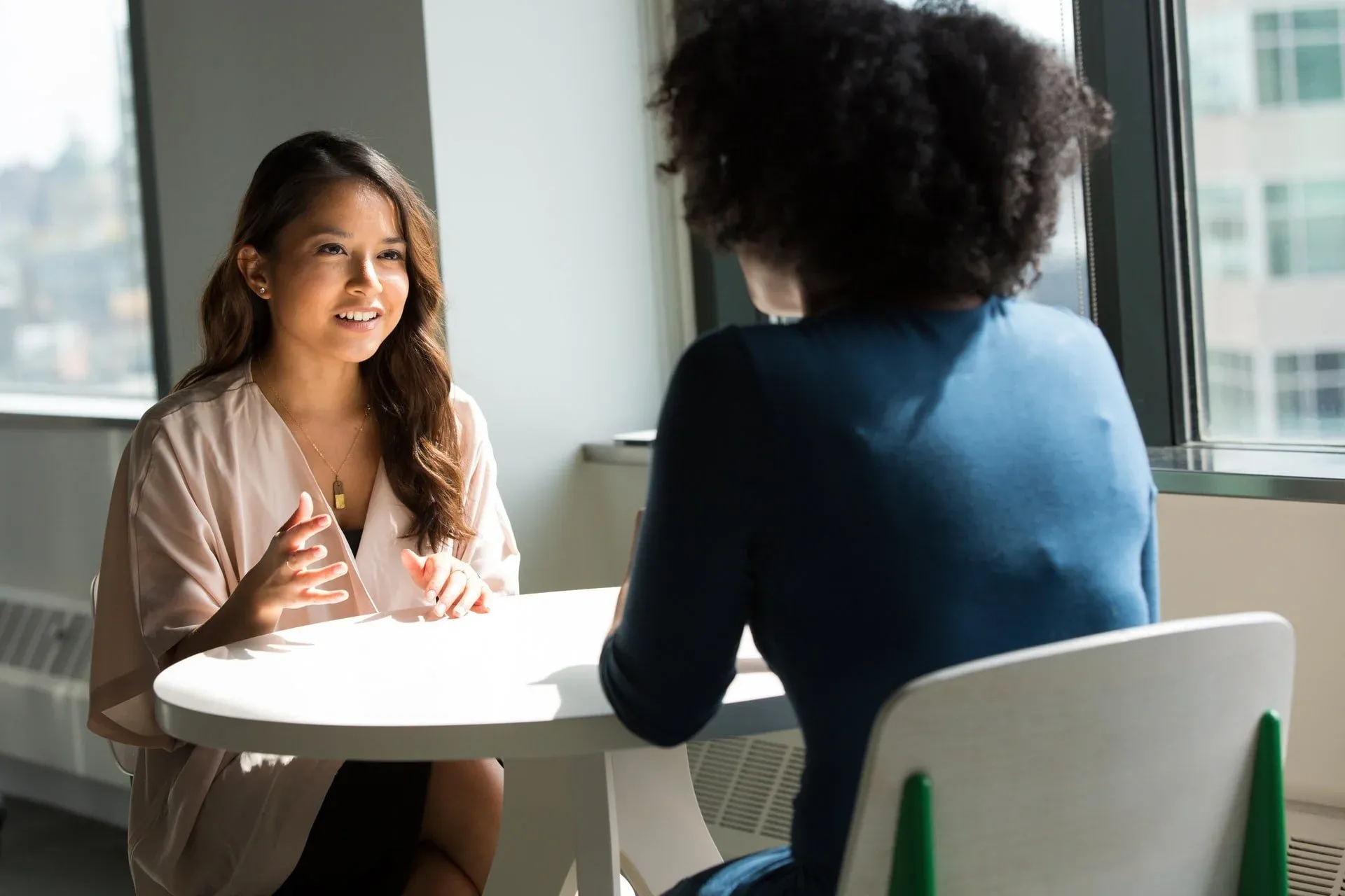 A person taking notes during an interview.
